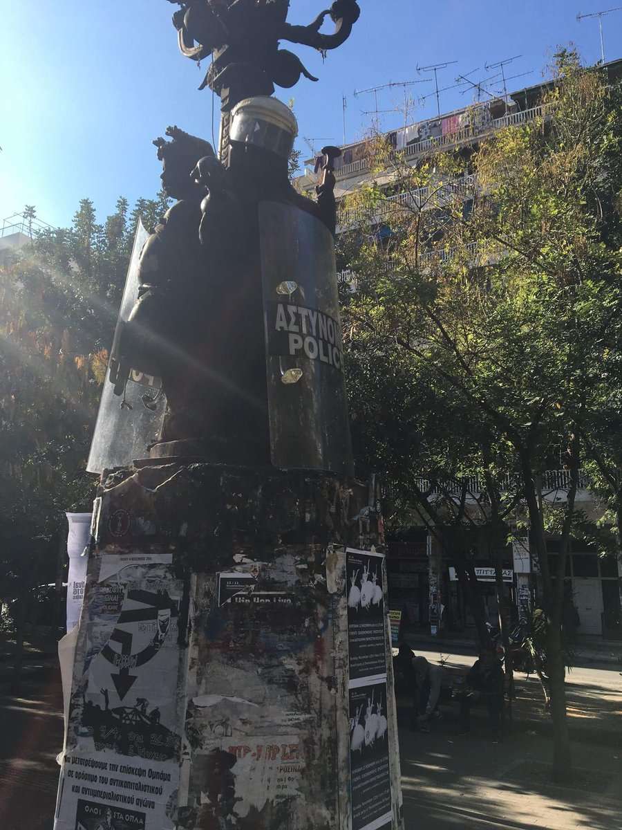 Athens, Greece: Traditional decorating of the statue in the Exarhia square with riot cop helmets and shields